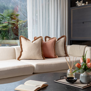 Beige sofa with decorative pillows in a living room setting