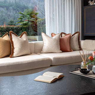 Living room with a sofa, coffee table, and decorative luxury cushions.

