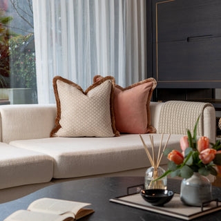 Decorative pillows on a sofa with a coffee table in the foreground